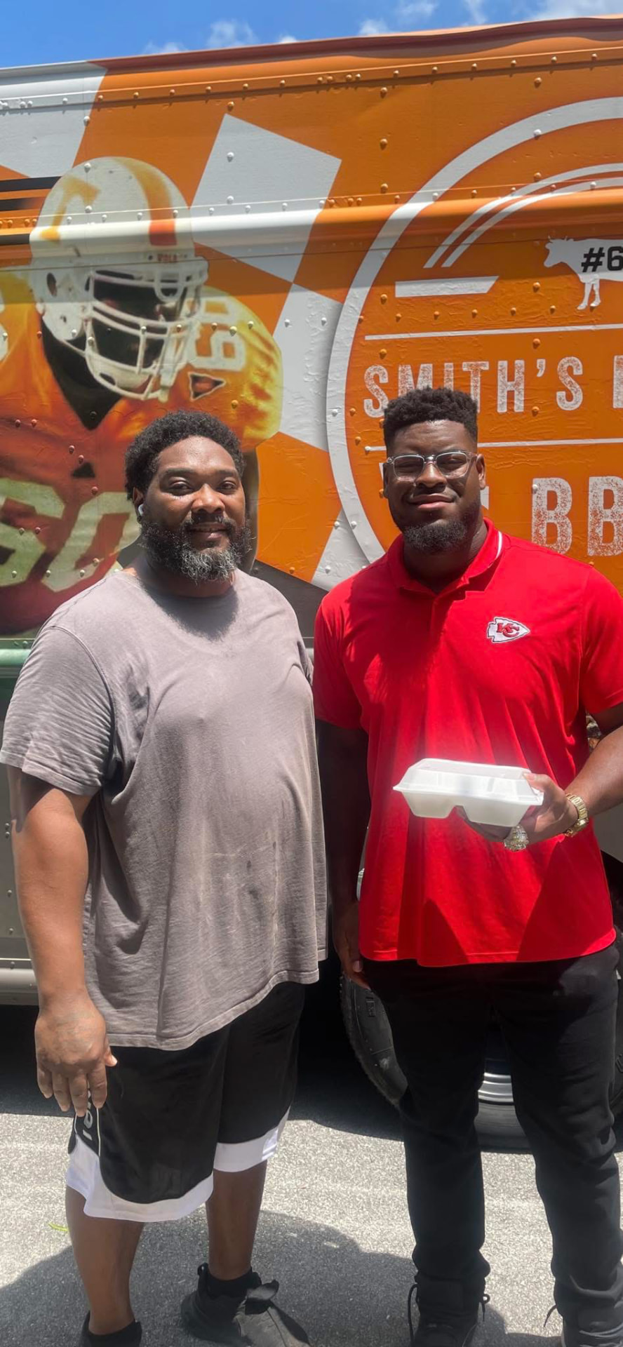 Chavis Smith with a customer at the BBQ truck