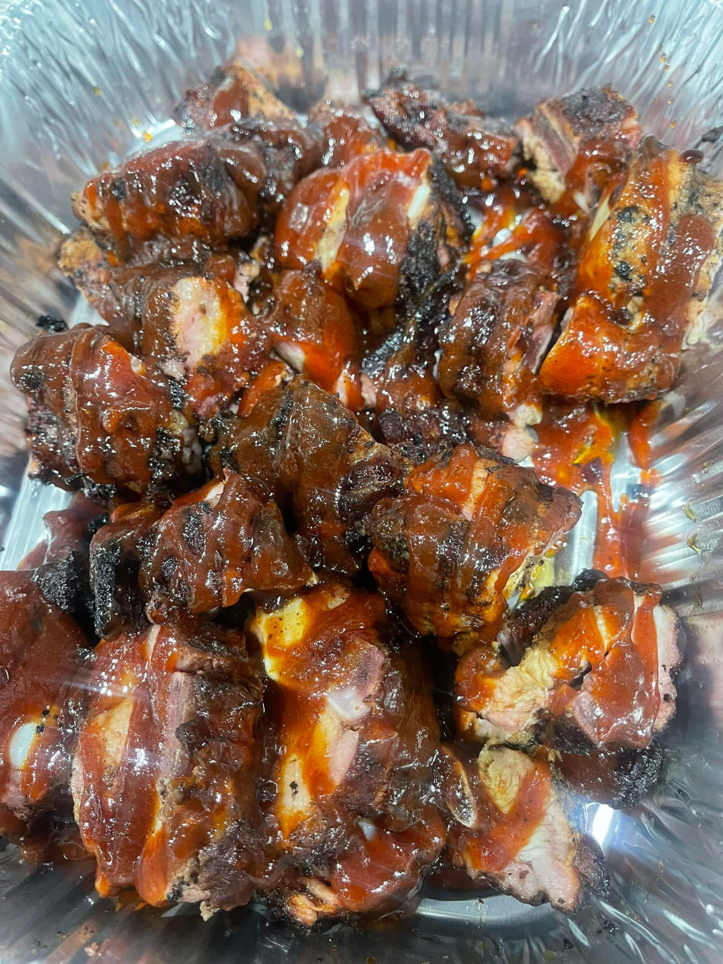 Saucy smoked rib tips in a catering pan